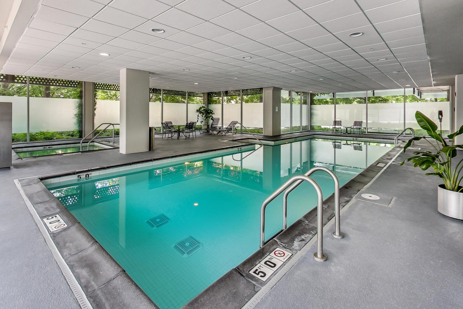 800 Elgin Road, Unit PH02 Evanston, IL 60201 - Photo 37 of 43 a swimming pool with large glass windows and outdoor seating