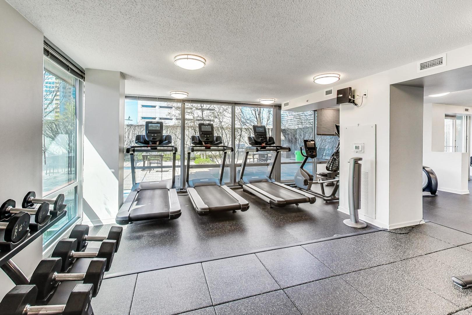 800 Elgin Road, Unit PH02 Evanston, IL 60201 - Photo 38 of 43 a view of a livingroom with furniture and floor to ceiling window