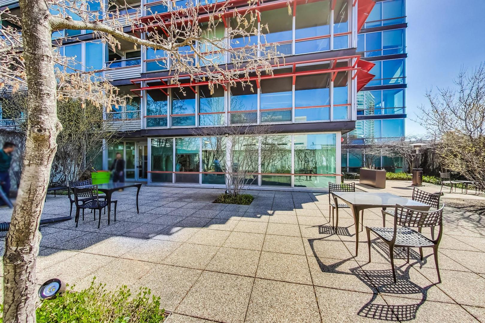 800 Elgin Road, Unit PH02 Evanston, IL 60201 - Photo 40 of 43 a view of a patio with a table and chairs under an umbrella
