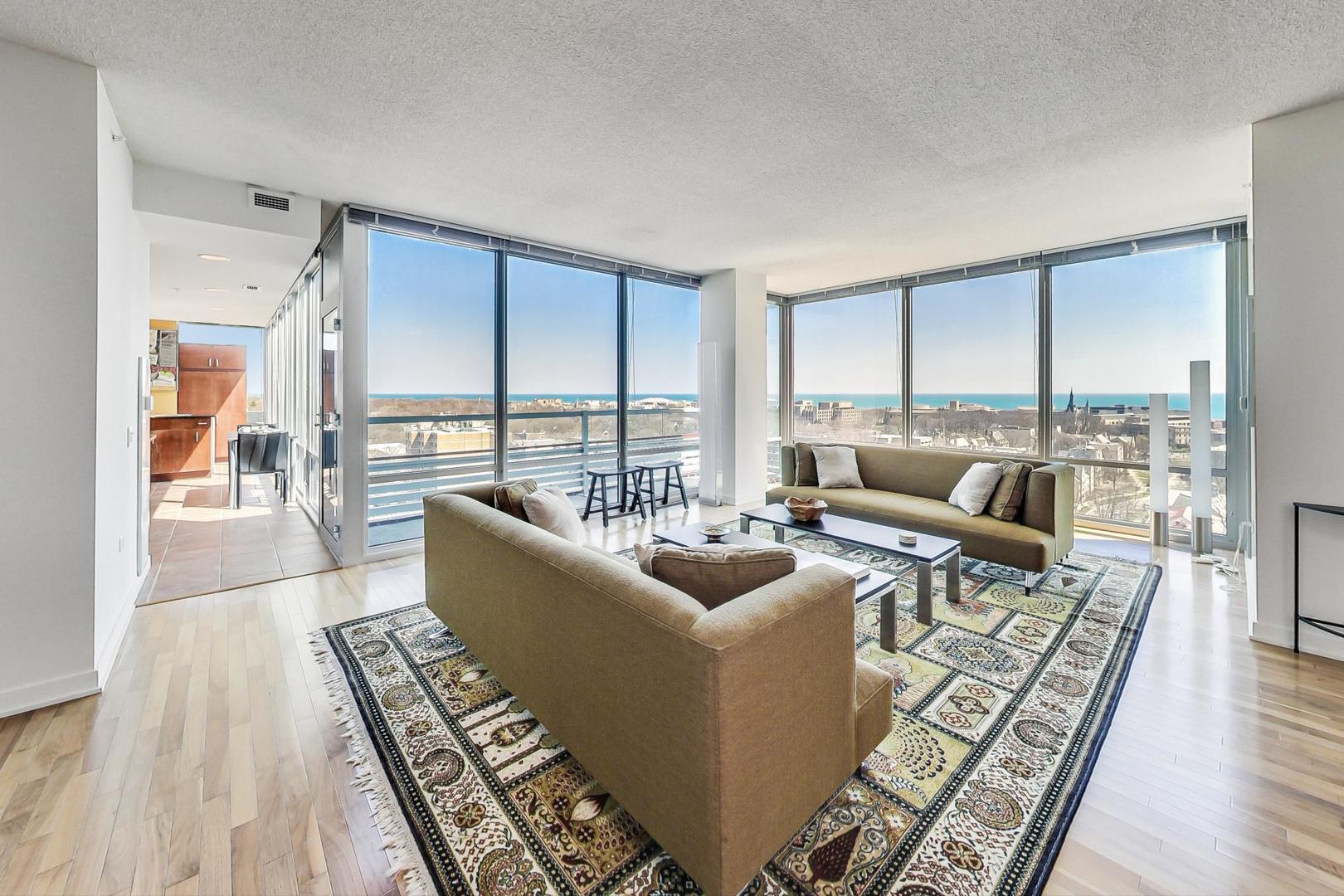 800 Elgin Road, Unit PH02 Evanston, IL 60201 - Photo 4 of 43 a living room with furniture large windows and wooden floor