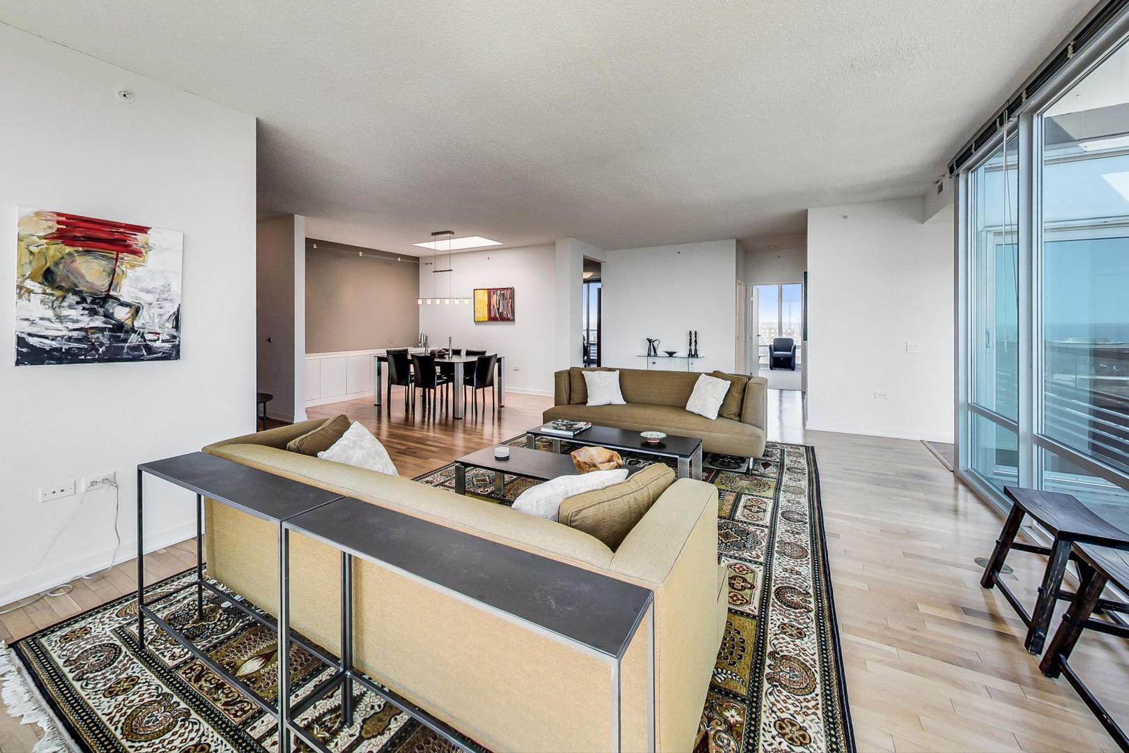 800 Elgin Road, Unit PH02 Evanston, IL 60201 - Photo 6 of 43 a living room with furniture and a table