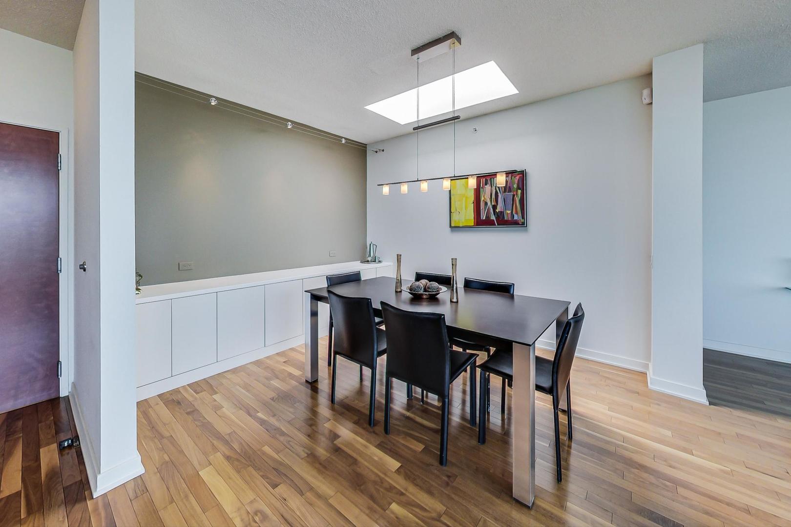 800 Elgin Road, Unit PH02 Evanston, IL 60201 - Photo 7 of 43 a view of a dining room with furniture and wooden floor