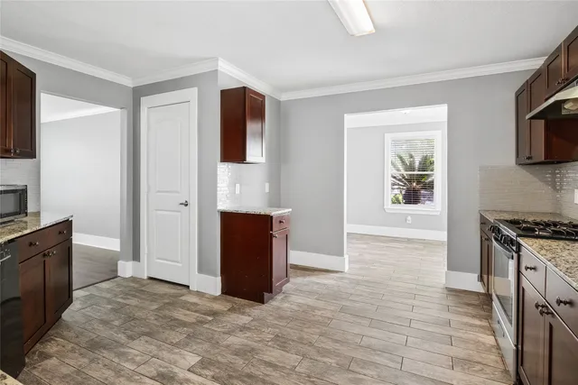 a view of kitchen with microwave oven and cabinets