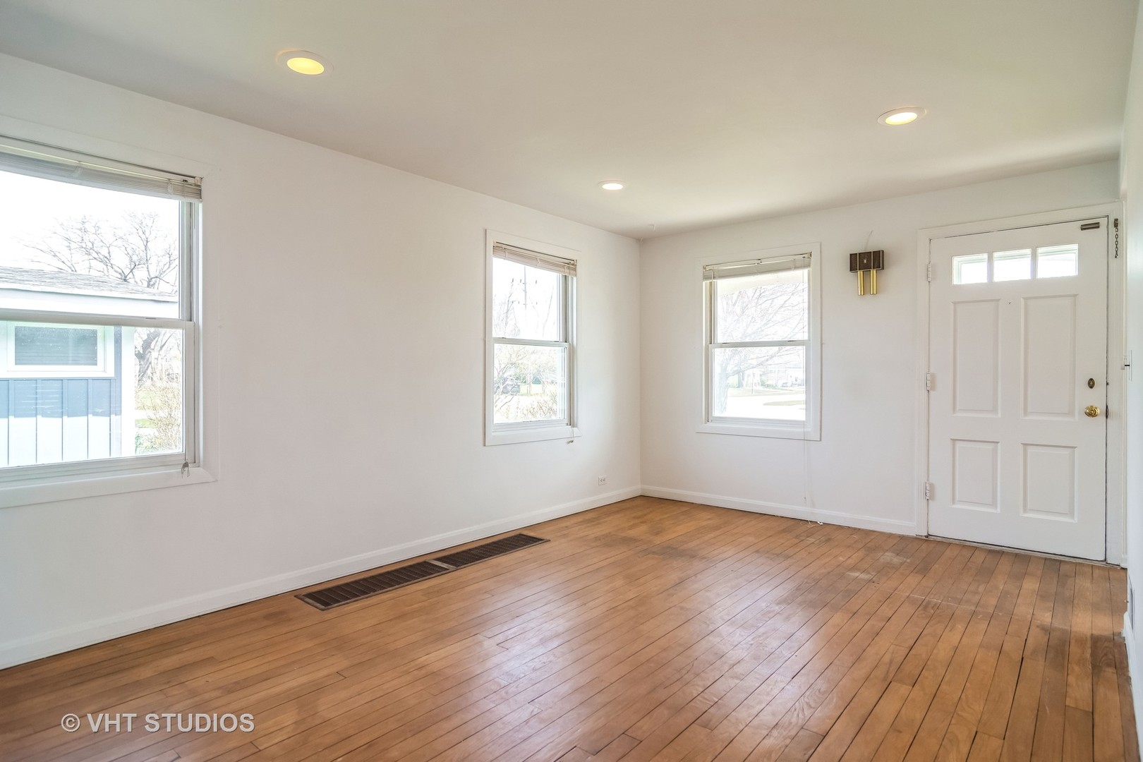 114 North Rohlwing Road Palatine, IL 60074 - Photo 5 of 16 an empty room with wooden floor and windows