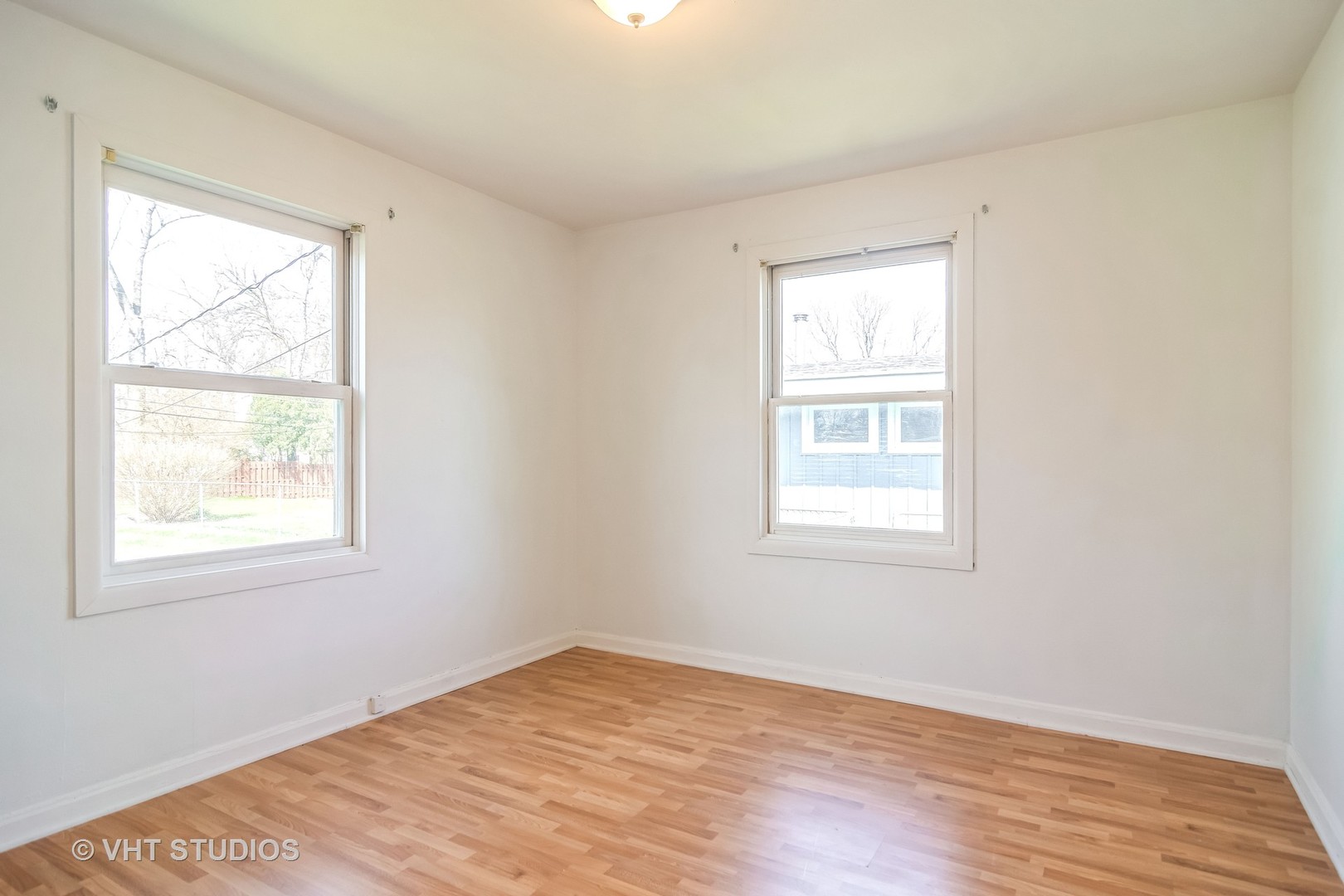 114 North Rohlwing Road Palatine, IL 60074 - Photo 8 of 16 an empty room with wooden floor and windows