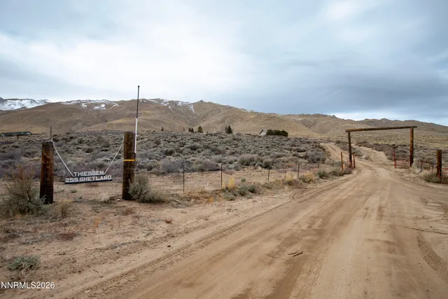 an aerial view of a house with a yard and lake view