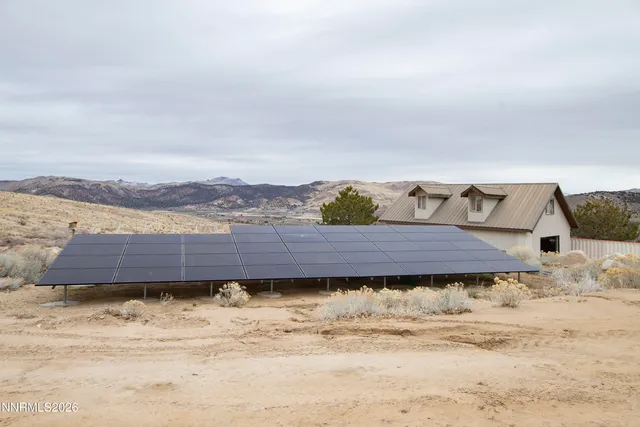 a living room with furniture a flat screen tv and a couch