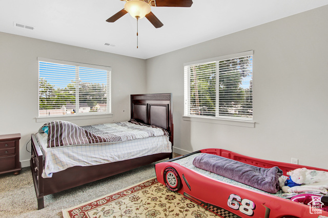 4 Hanauer Place Murray, UT 84107 - Photo 15 of 24 Bedroom featuring a ceiling fan and carpet