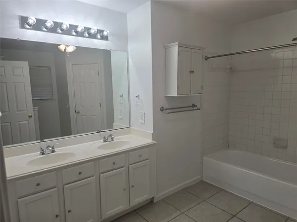 a bathroom with a shower and a bath tub