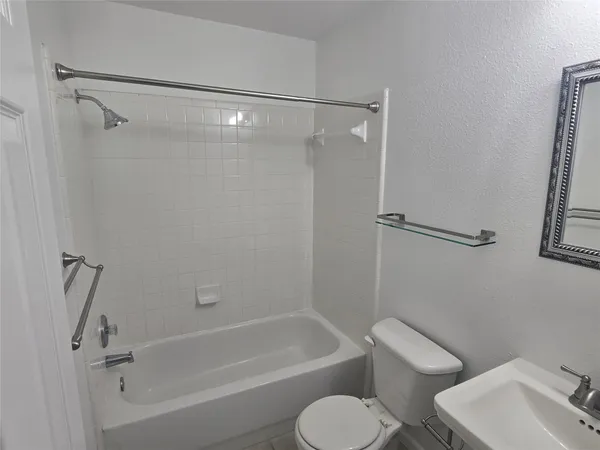 a bathroom with a toilet and a bath tub
