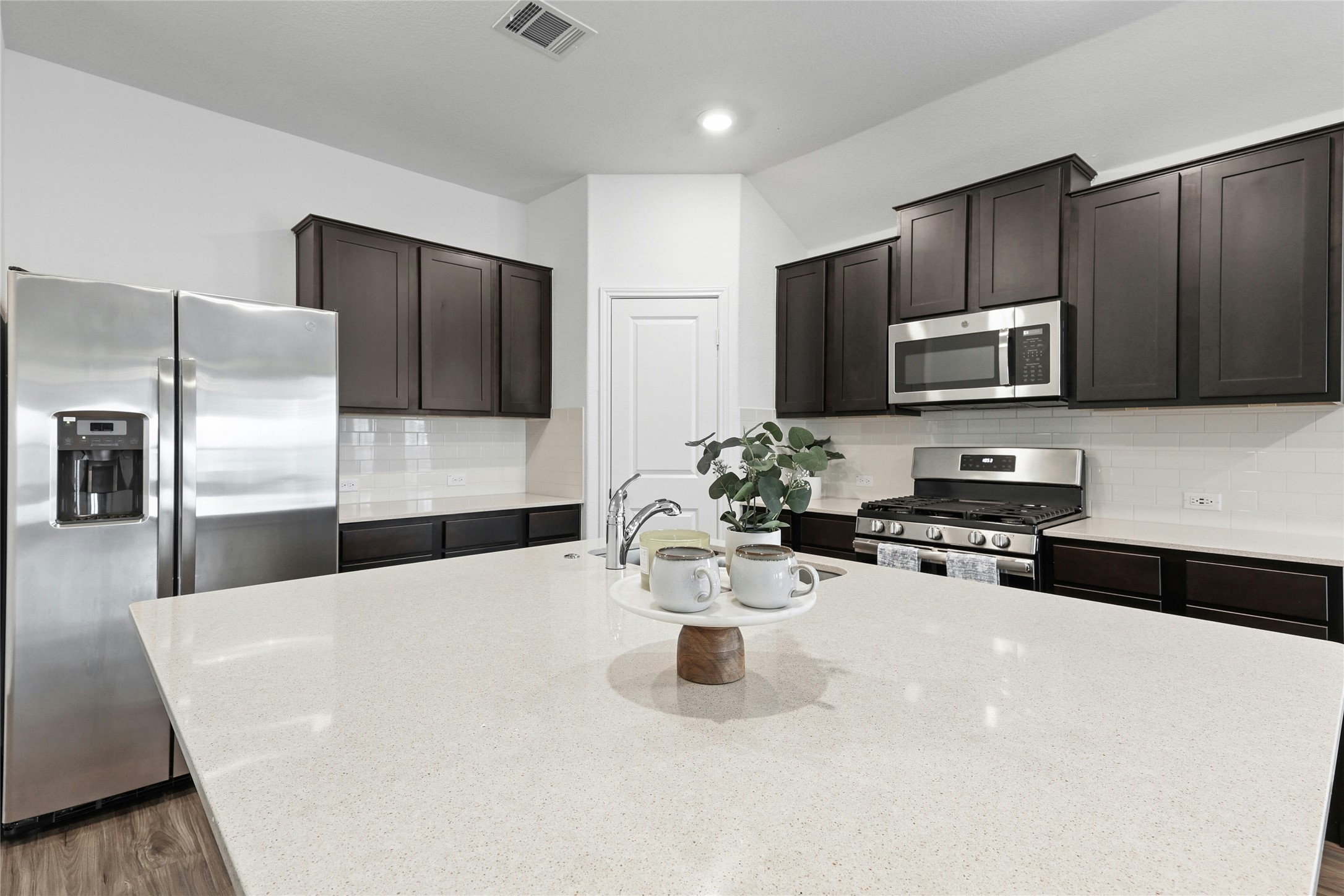 11813 Roscommon Trail Austin, TX 78754 - Photo 10 of 28 a kitchen with stainless steel appliances a microwave sink and refrigerator