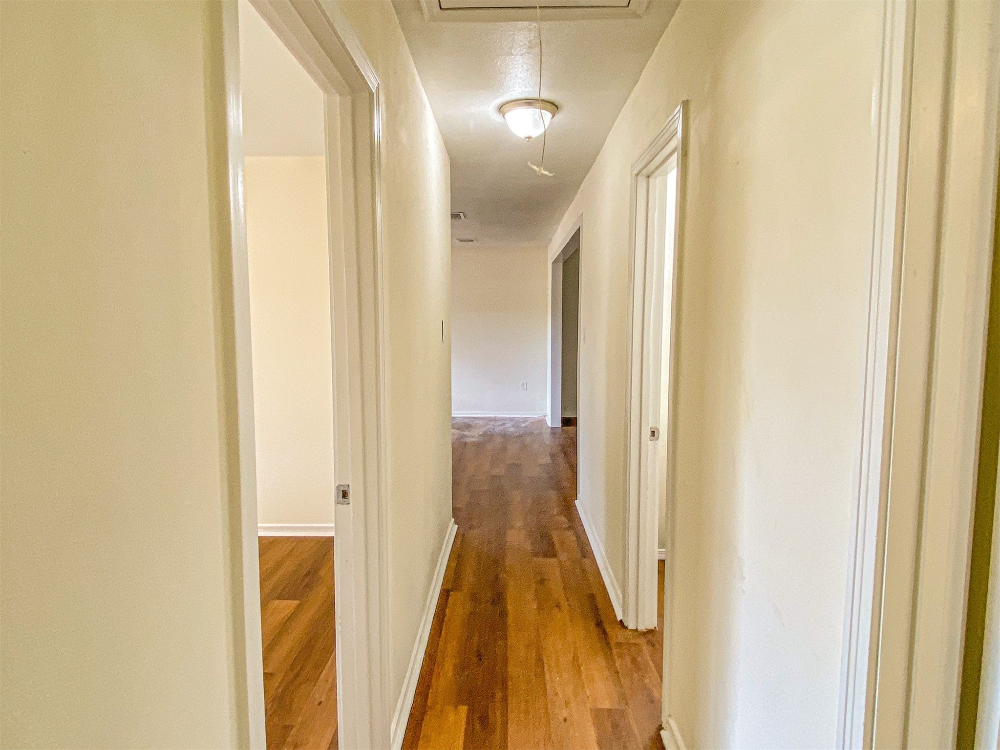 3815 Commerce Street Damon, TX 77430 - Photo 12 of 16 a view of a hallway with wooden floor