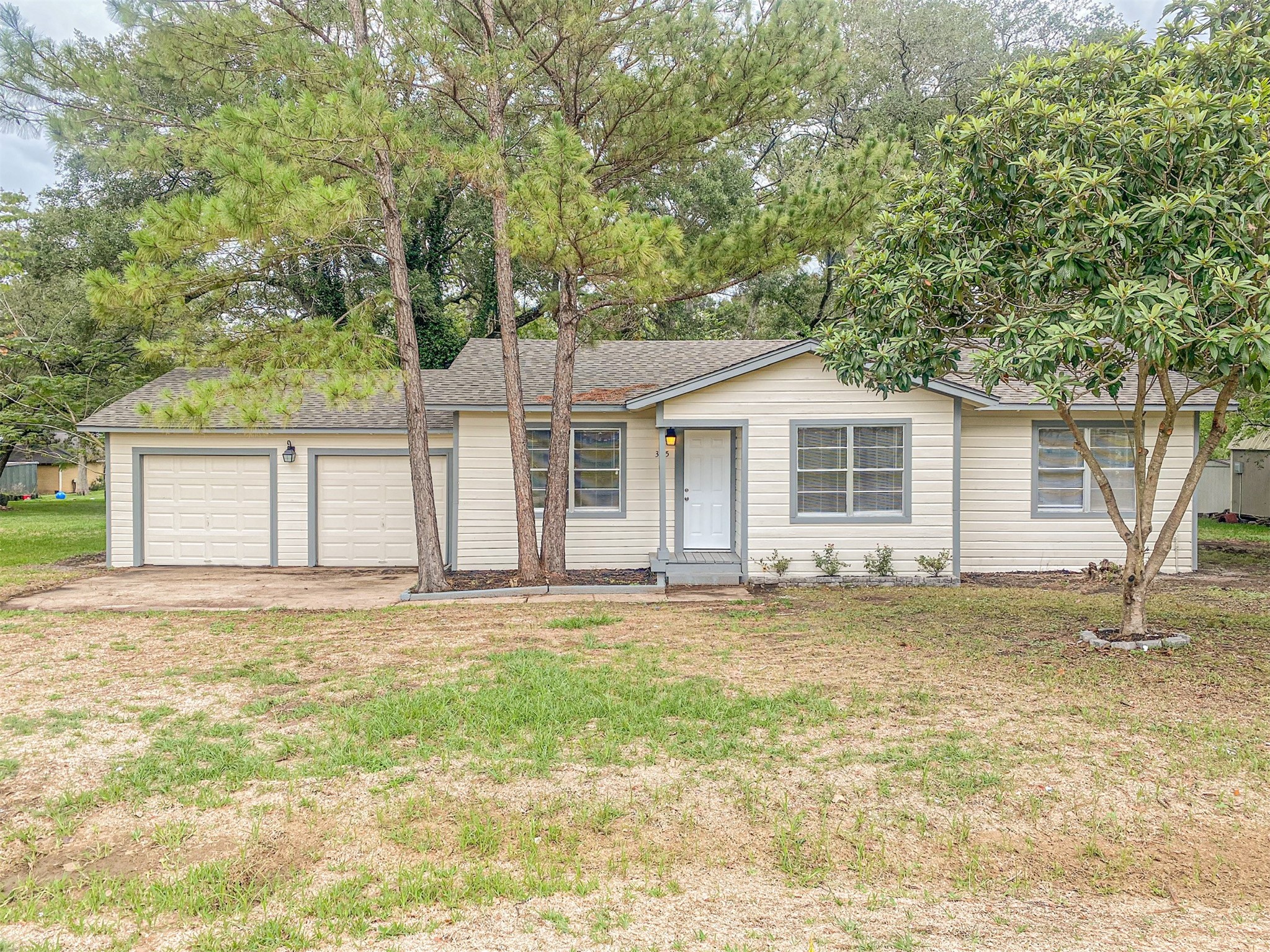 3815 Commerce Street Damon, TX 77430 - Photo 5 of 16 a house that has a tree in front of it