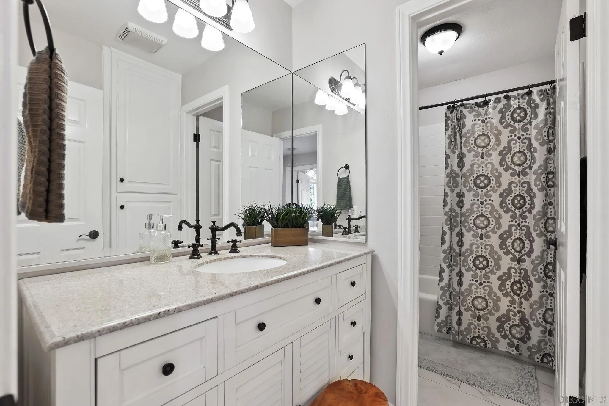 750 Jericho Drive Fallbrook, CA 92028 - Photo 32 of 69 a bathroom with a granite countertop sink a mirror a vanity and shower