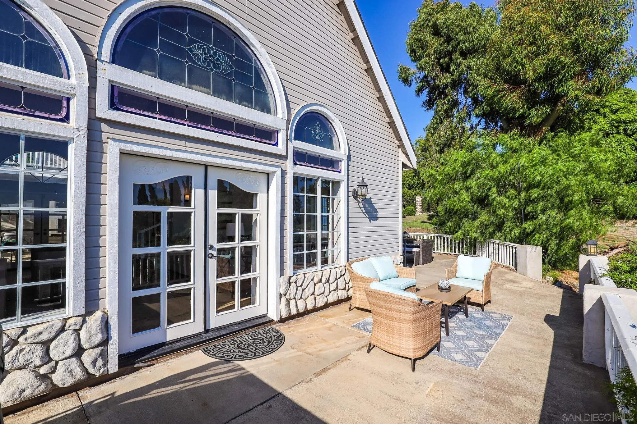 750 Jericho Drive Fallbrook, CA 92028 - Photo 43 of 69 a view of a patio of the house with a floor to ceiling window and wooden fence