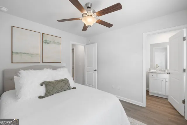 a bathroom with a granite countertop sink a toilet and shower