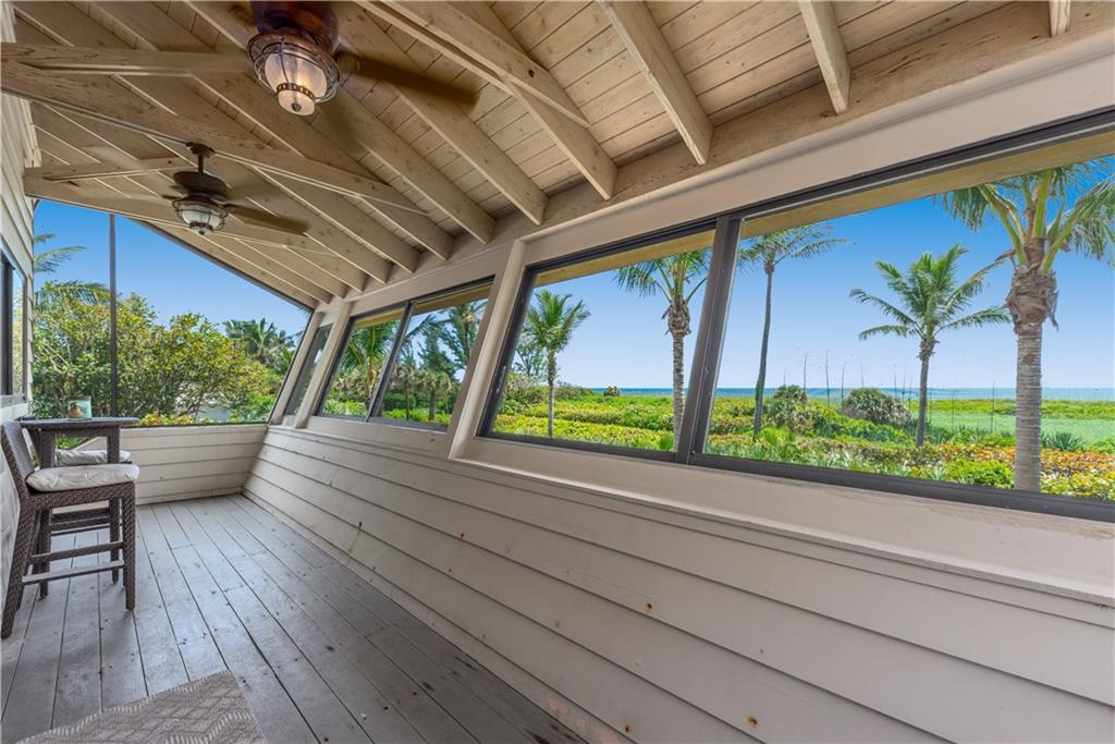 88 North Beach Road Hobe Sound, FL 33455 - Photo 20 of 30 You gain access to the master suite by a breezeway from the first floor or the elevator. This screened porch is part of the master suite. That's the Atlantic Ocean past the palms.
