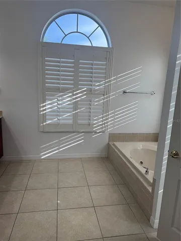 a bathroom with a tub and a shower