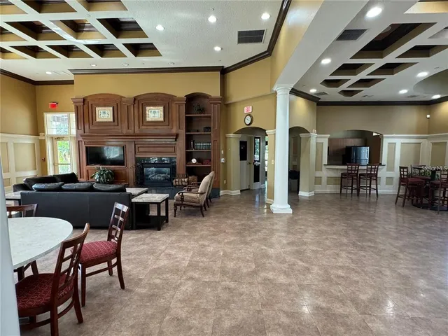 a living room with lots of furniture and kitchen view