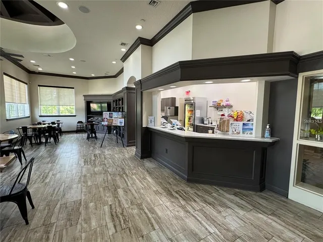 a living room with lots of furniture and a large window