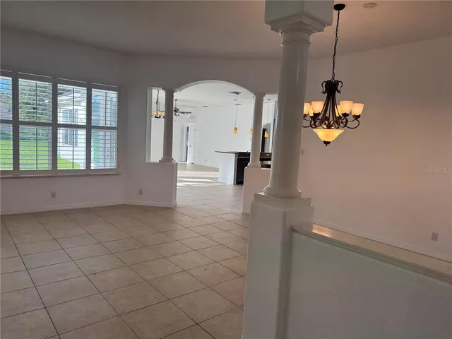 a view of a room with wooden floor and windows