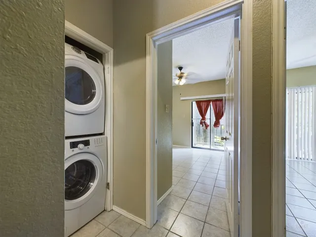 a view of a hallway with washer and dryer