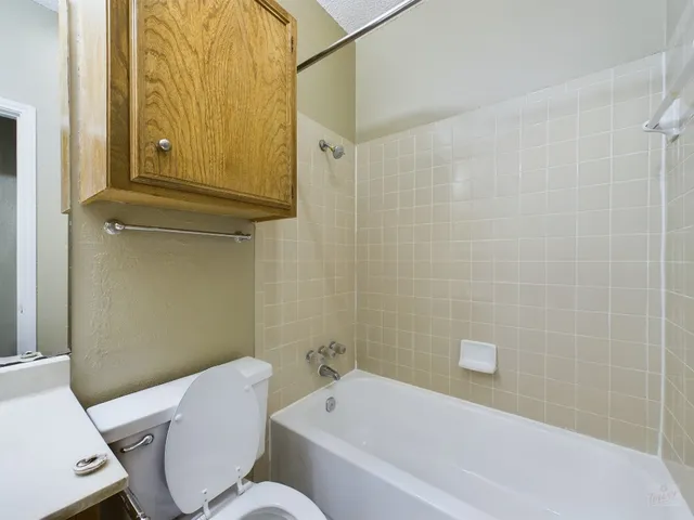 a bathroom with a toilet a sink and bathtub