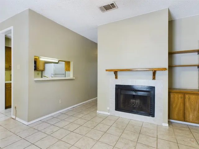 a view of an empty room with a fireplace