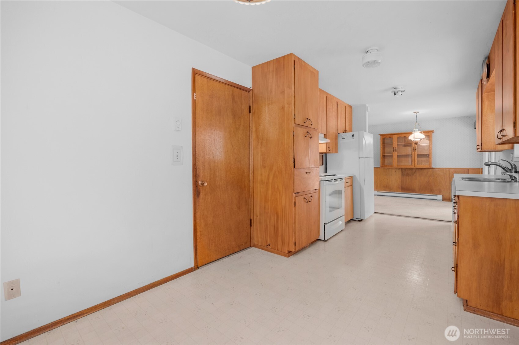 22221 45th Avenue Southeast Bothell, WA 98021 - Photo 11 of 32 a view of a kitchen with refrigerator and wooden floor
