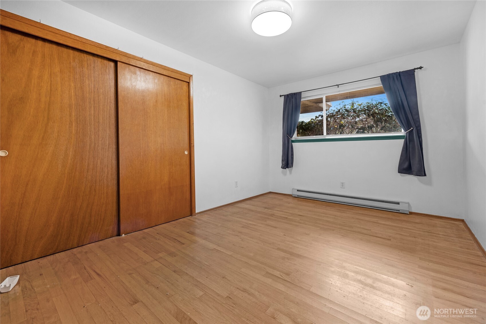 22221 45th Avenue Southeast Bothell, WA 98021 - Photo 13 of 32 a view of an empty room with a window and closet