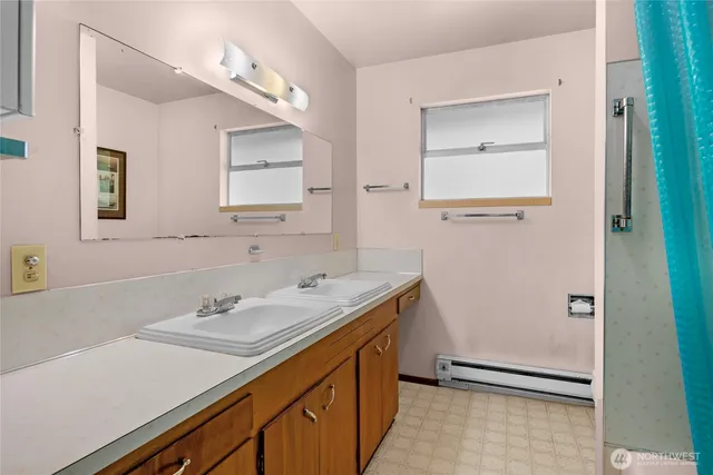 a bathroom with a sink a mirror and a shower