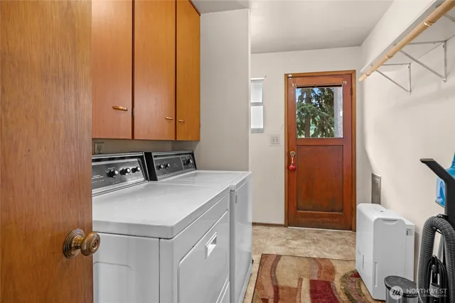 a view of a storage and utility room with washer and dryer