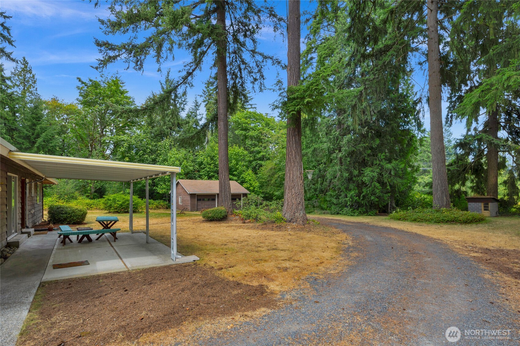 22221 45th Avenue Southeast Bothell, WA 98021 - Photo 18 of 32 a view of a patio with a table and chairs under an umbrella