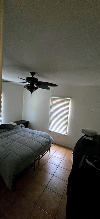 14820 County Road 48 Astatula, FL 34705 - Photo 11 of 12 a bed sitting in a bedroom next to a window