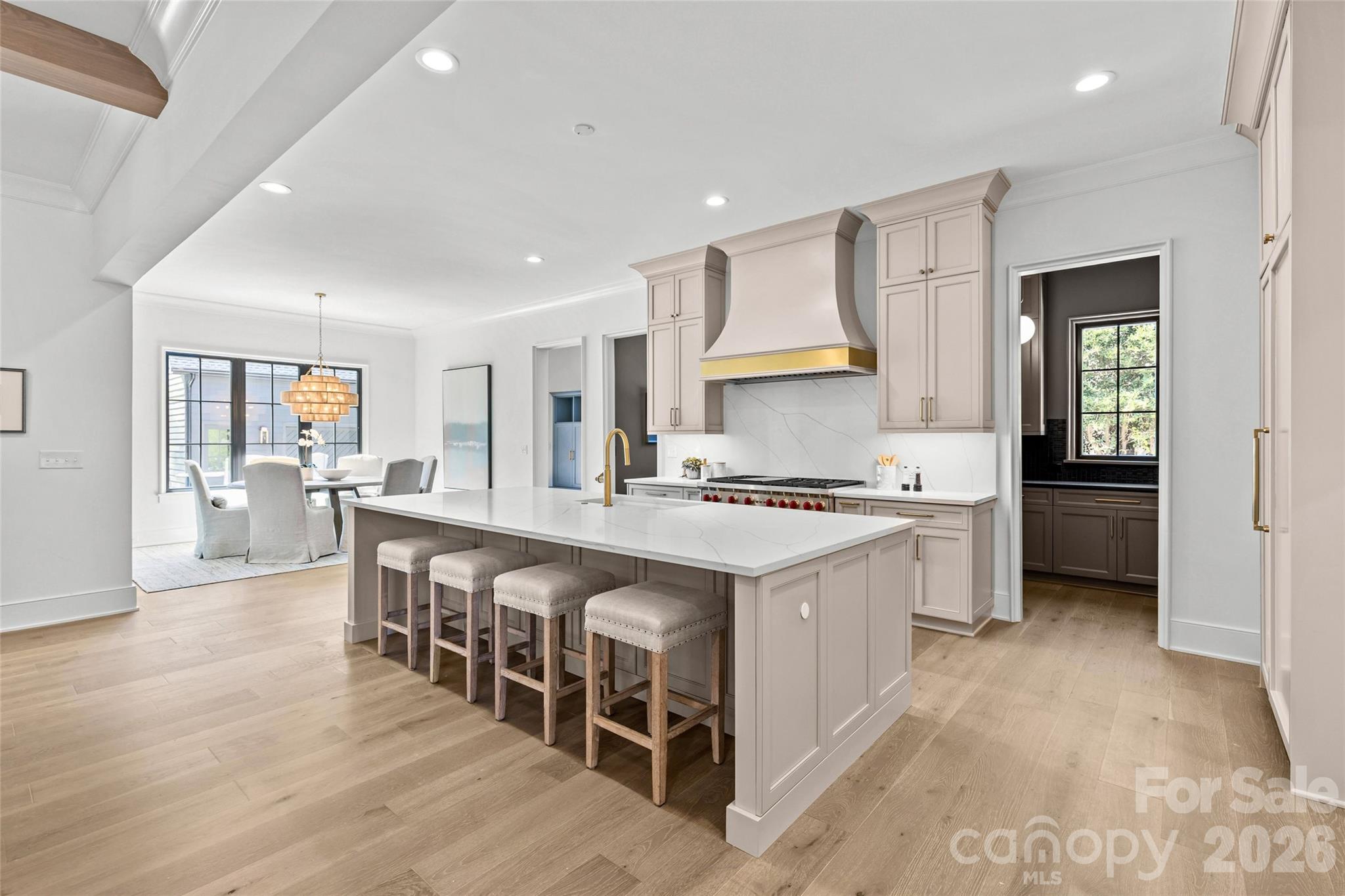 1321 Ferncliff Road Charlotte, NC 28211 - Photo 12 of 47 a large kitchen with kitchen island a sink a stove a table and chairs
