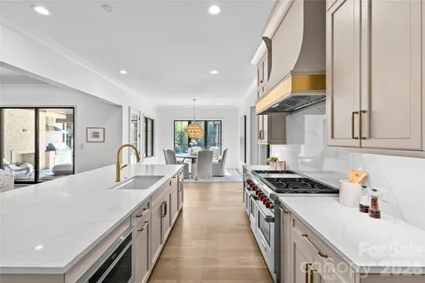 a kitchen with stove a sink and cabinets