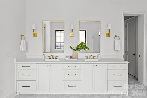 a bathroom with a sink vanity and mirror