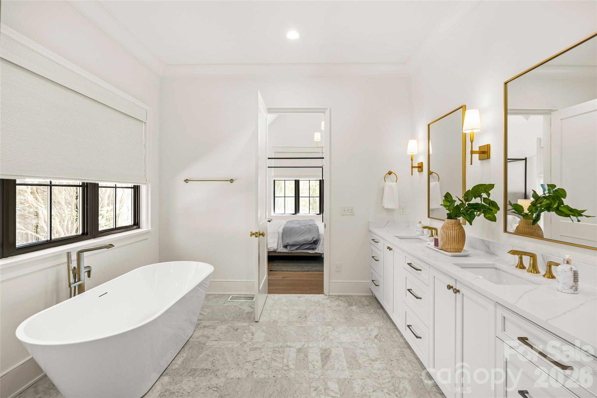 1321 Ferncliff Road Charlotte, NC 28211 - Photo 22 of 47 a bathroom with a double vanity sink a mirror and a bathtub