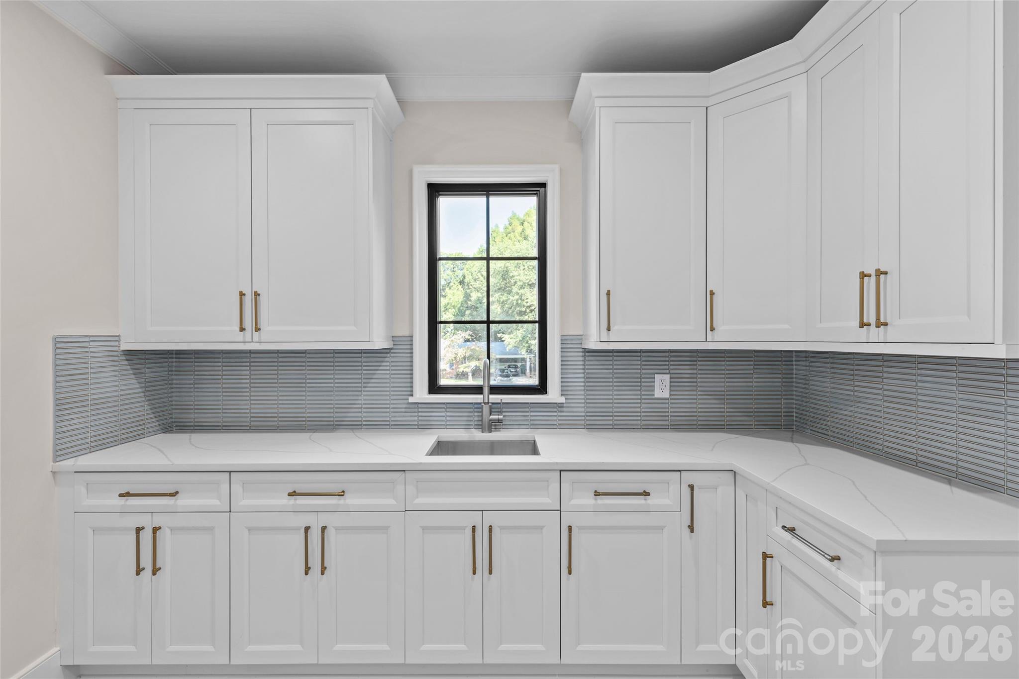 1321 Ferncliff Road Charlotte, NC 28211 - Photo 27 of 47 a kitchen with granite countertop white cabinets and sink