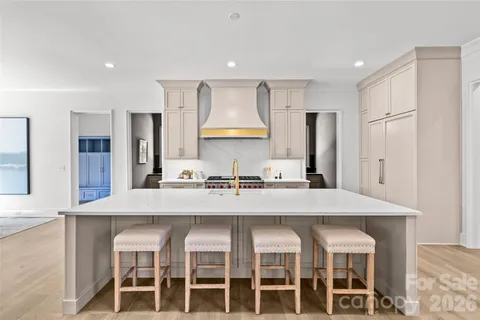 a large kitchen with a table and chairs