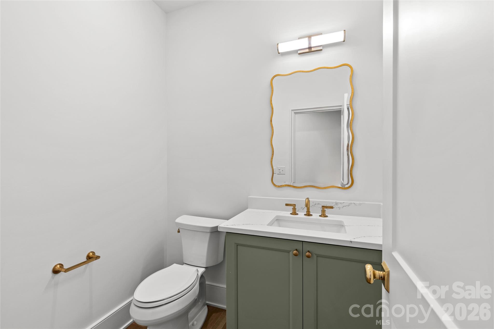 1321 Ferncliff Road Charlotte, NC 28211 - Photo 32 of 47 a bathroom with a toilet sink vanity and mirror