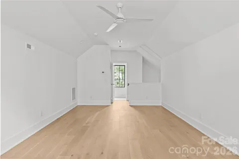 an empty room with windows and cabinet