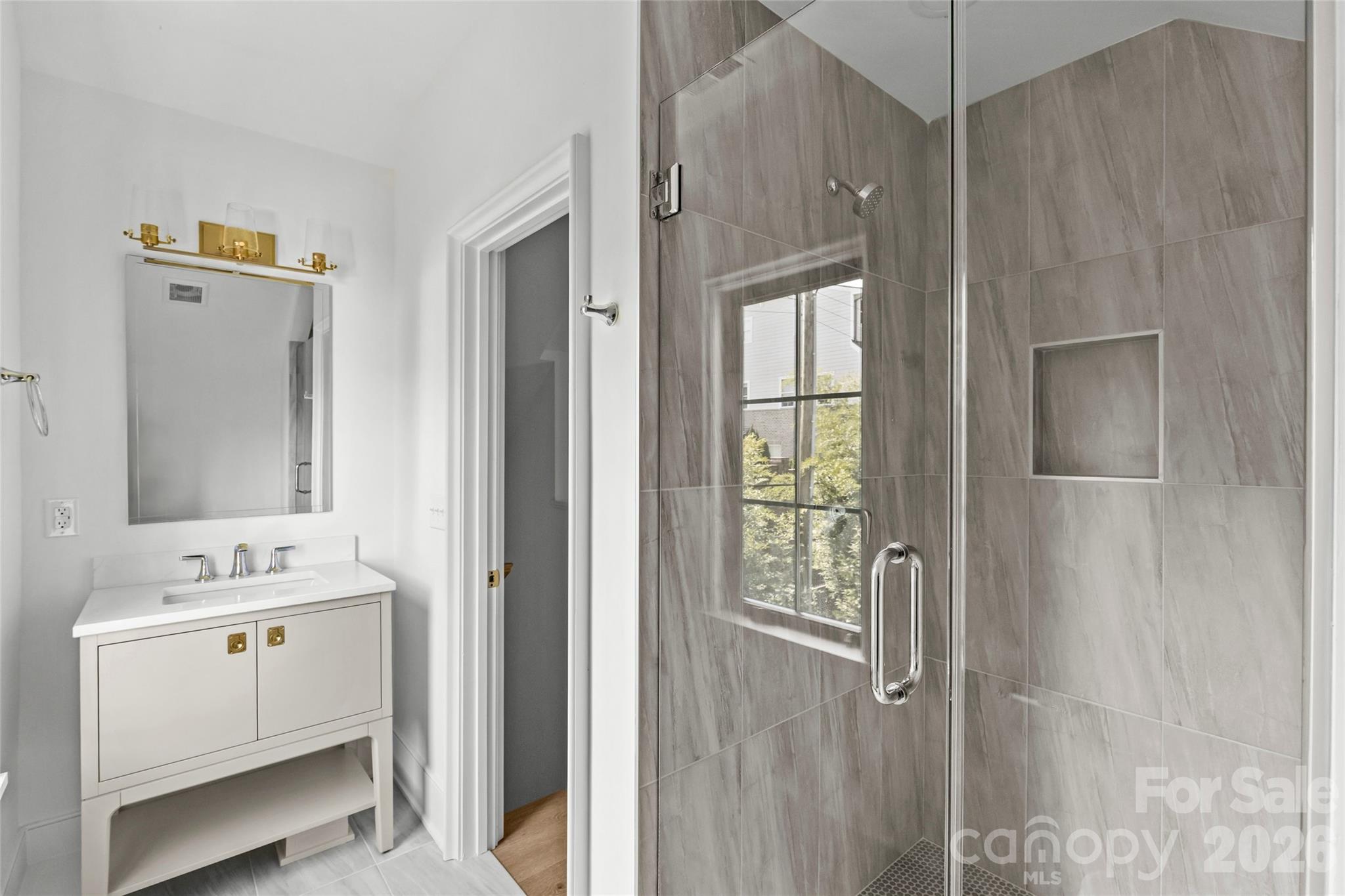 1321 Ferncliff Road Charlotte, NC 28211 - Photo 44 of 47 a bathroom with a sink a mirror and a shower