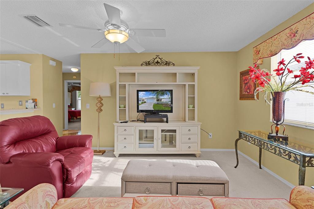 2623 Ascot Loop The Villages, FL 32162 - Photo 4 of 40 a living room with furniture a chandelier and a fireplace