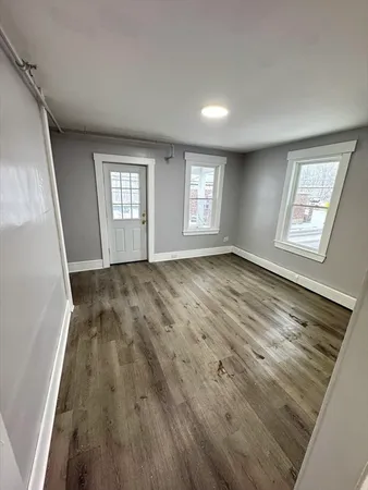 wooden floor in an empty room with a window