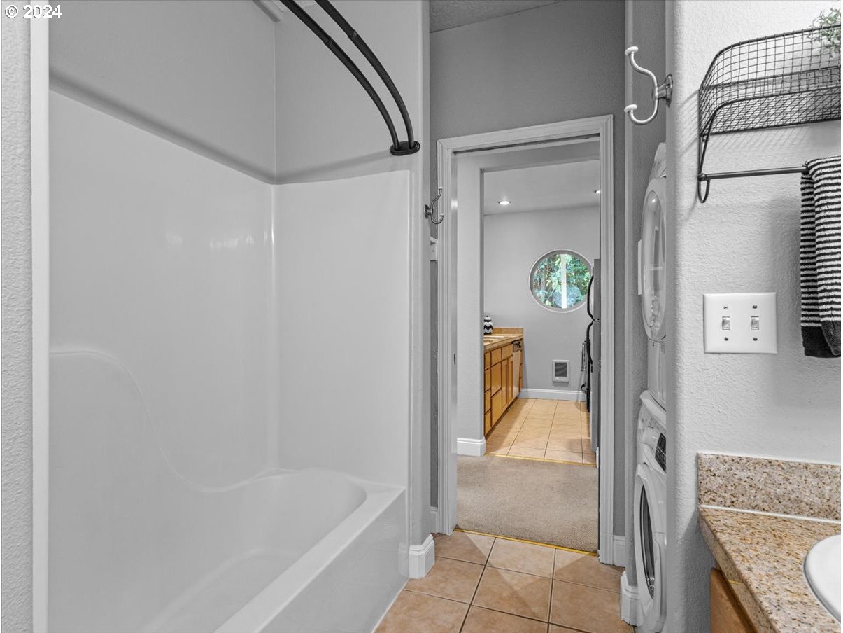 5221 Southwest View Point Terrace, Unit 2 Portland, OR 97239 - Photo 19 of 30 a bathroom with a tub and shower