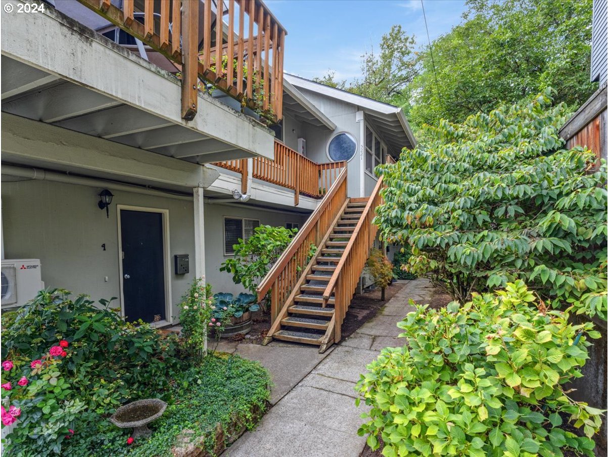 5221 Southwest View Point Terrace, Unit 2 Portland, OR 97239 - Photo 2 of 30 a view of a house with a flower garden