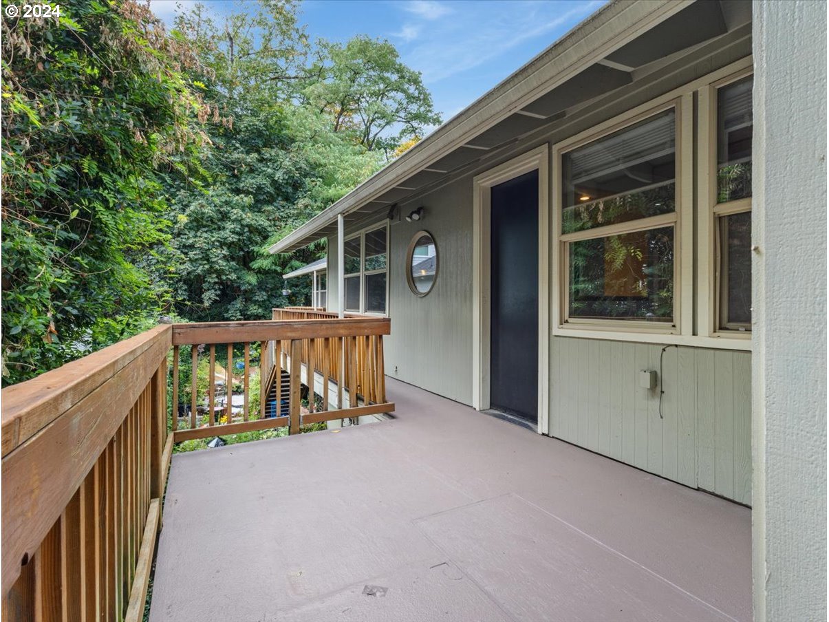 5221 Southwest View Point Terrace, Unit 2 Portland, OR 97239 - Photo 21 of 30 a view of balcony with deck and trees