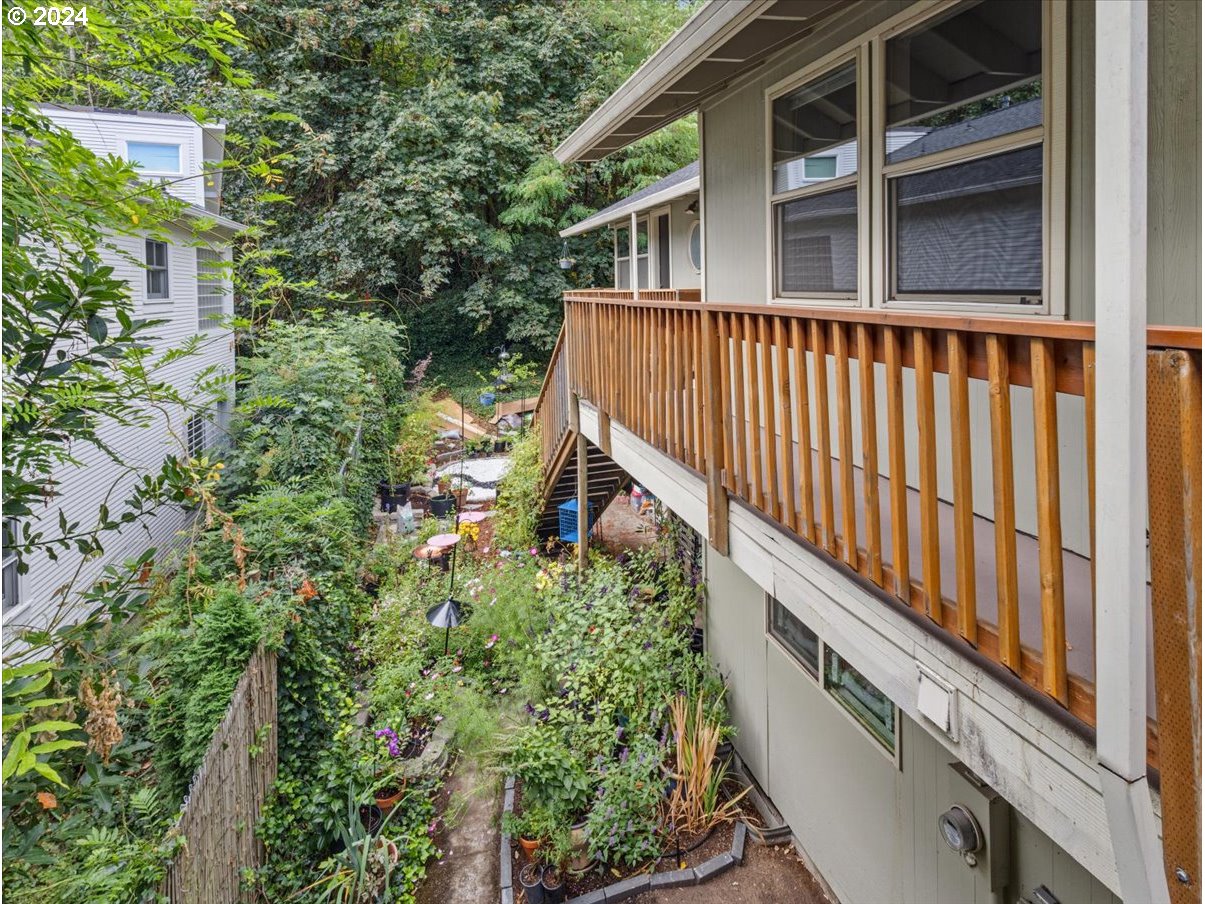 5221 Southwest View Point Terrace, Unit 2 Portland, OR 97239 - Photo 22 of 30 a balcony with lots of green trees in the background