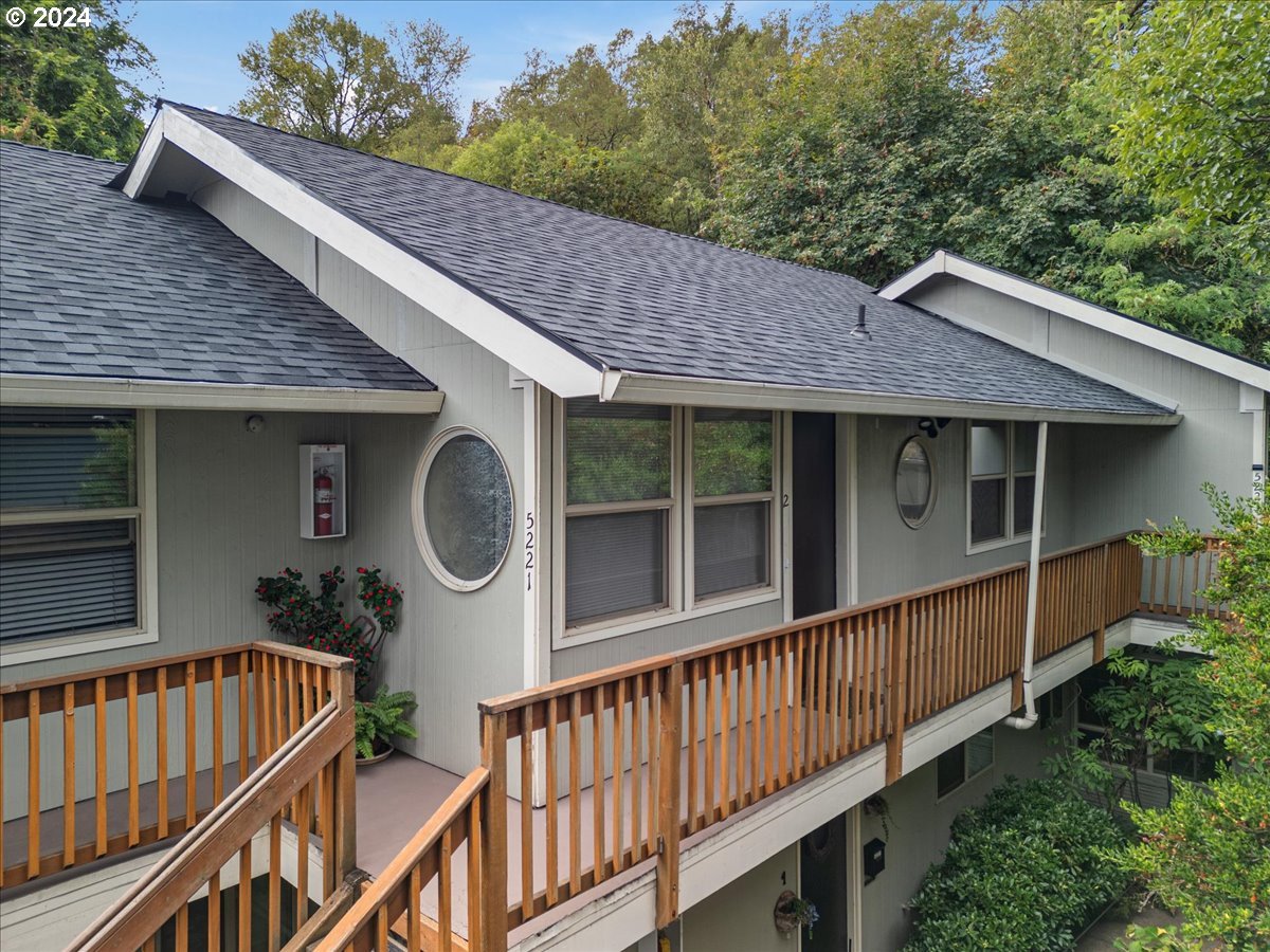 5221 Southwest View Point Terrace, Unit 2 Portland, OR 97239 - Photo 3 of 30 a view of a house with wooden deck and a garden
